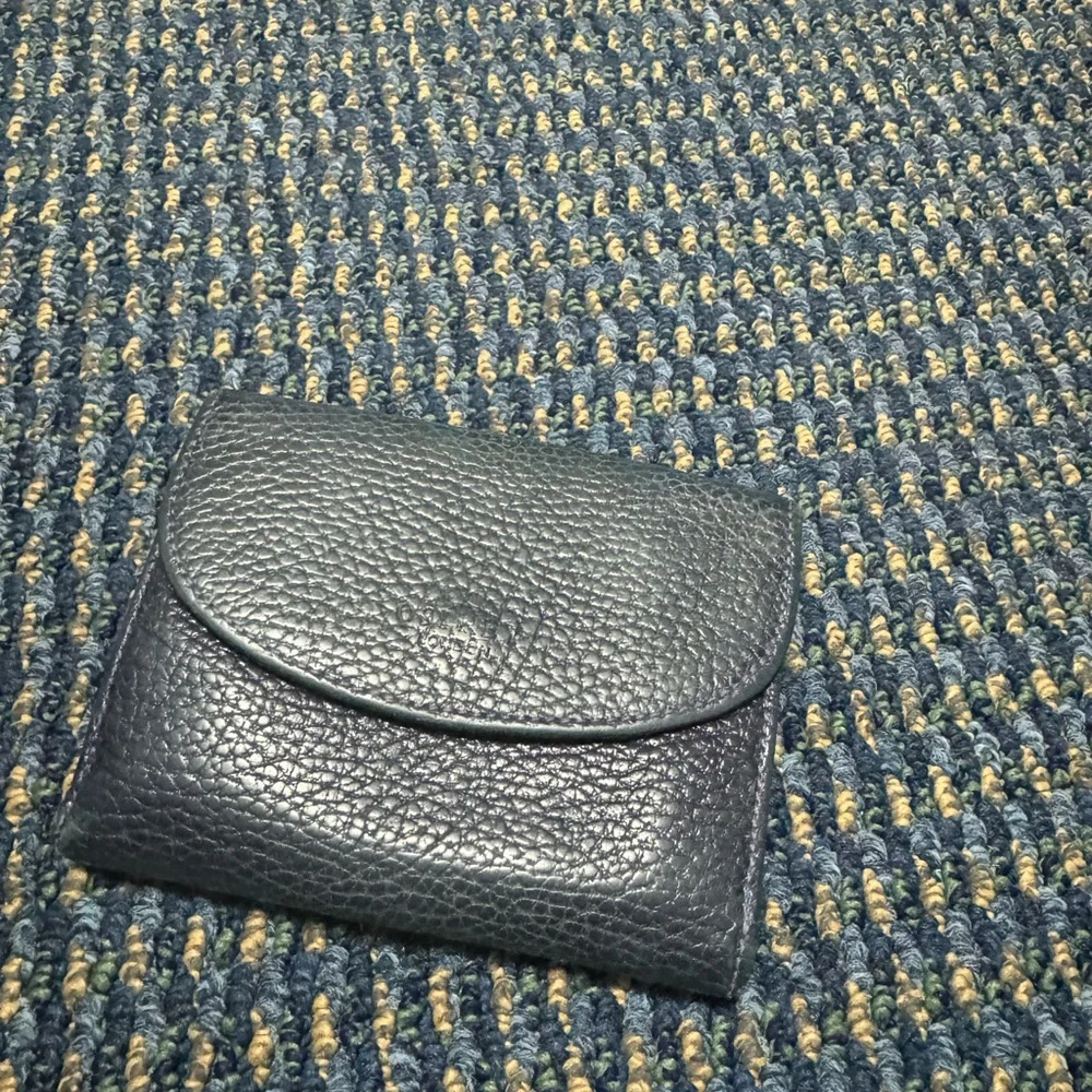 Dark navy leather wallet with exterior coin compartment. GUC